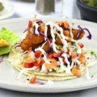 Baja Shrimp Taco · Baja shrimp taco includes breaded shrimp and is topped with cabbage, sour cream, chipotle sa...