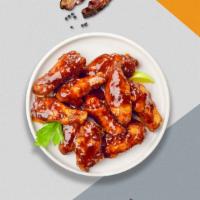 Barely Bourbon Wings · Fresh chicken wings breaded, fried until golden brown, and tossed in borbon sauce. Served wi...