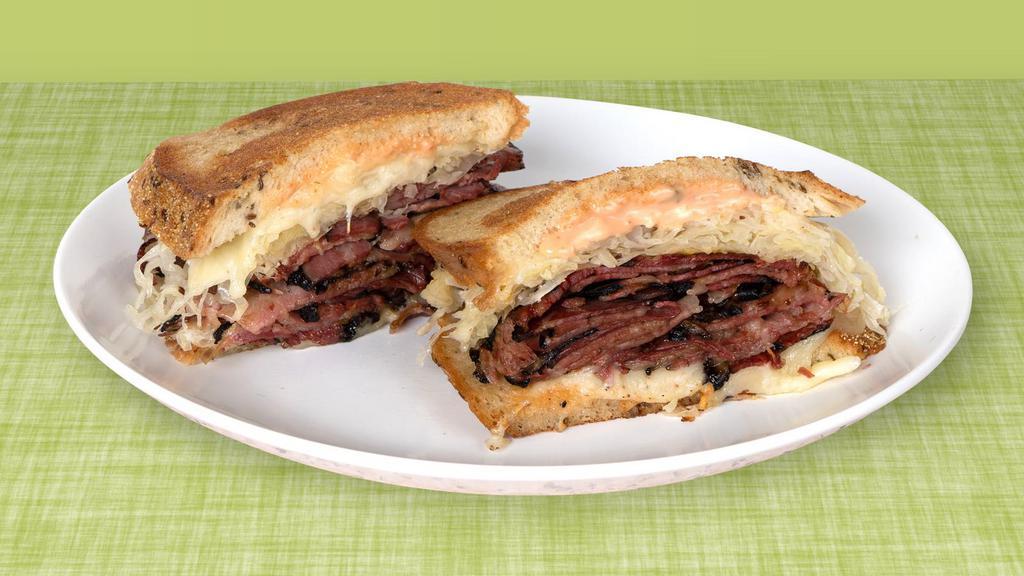 Pastrami Reuben · Dry-aged pastrami with sauerkraut, Russian dressing, and Swiss cheese on grilled rye.