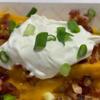 Loaded Fries · FRENCH FRIES LOADED WITH NACHO CHEESE, BACON, SOUR CREAM AND GREEN ONIONS.