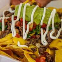 Loaded Nachos · Meat choice, homemade chips, topped with cheese sauce, whole beans, pico de gallo, sour crea...