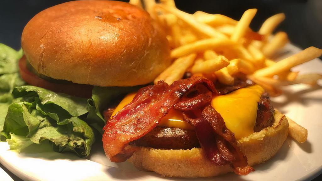 Bacon Cheddar Burger · Ground chuck patty with bacon and cheddar cheese. It comes with lettuce, tomato, and pickles. Choice of one side.
