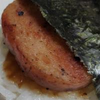 Spam Musubi · sliced of grilled spam on top of a block of rice , wrapped together with nori and house sauce.