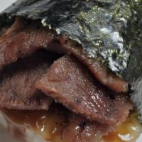 Grill Beef Musubi · Grilled teriyaki beef on top of a block of rice , wrapped together with nori and house sauce.
