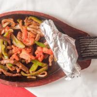 Fajitas · Seared sizzling hot. With bell peppers and onions, a side of guacamole, tortillas and refrie...