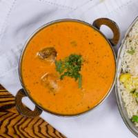 Malai Kofta · Minced vegetable balls cooked in a cream sauce and garnished with cashews and raisins.
