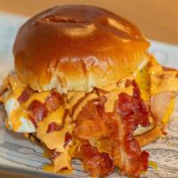 Breakfast Burger · Served on a Brioche Bun, Over Easy Egg, Bacon, Cheese, Mayo, Red Pepper Sauce, and Tater Tot...