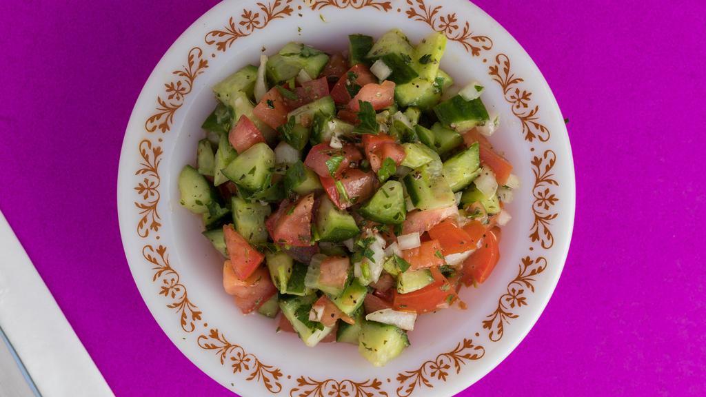 Shirazi Salad · Diced Cucumbers, Tomatoes, Onions and Parsley with Lemon Dressing.