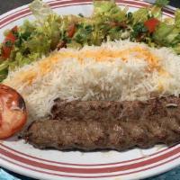 Chelo Kabab Koobideh · Seasoned ground sirloin mixed with grated onions and rolled around skewer, broiled on open f...