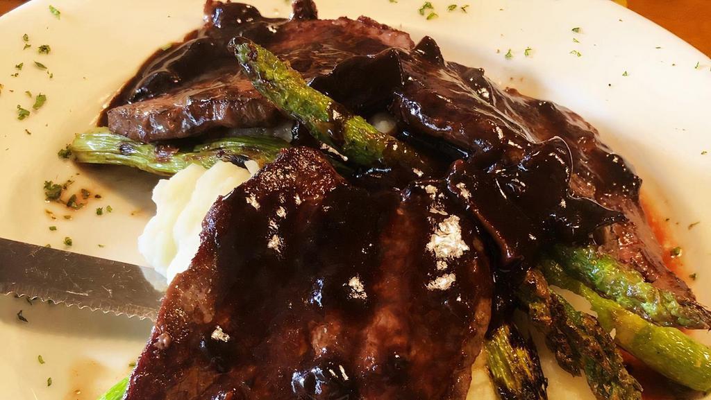 Steak Dianne · Grilled fillet mignon medallions with red wine mushrooms and balsamic sauce served with mashed potatoes and grilled asparagus.