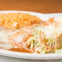Enchiladas De Chile Con Carne · Three enchiladas smothered in chile con carne sauce stuffed with your choice. Served with ri...