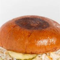 Rebel · A juicy plant based chicken patty, served on a brioche bun, 24k sauce, slaw, and pickles.