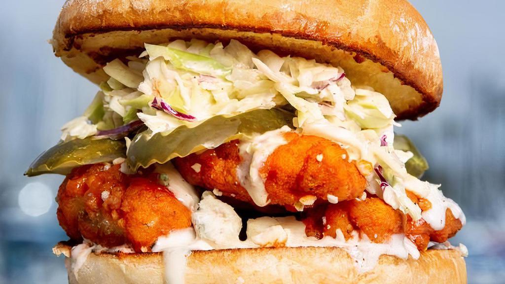 Buffalo Chicken Sandwich · Tender chicken tossed in a mild buffalo sauce and blue cheese crumbles topped with coleslaw & sliced dill pickle on a soft potato bun.
