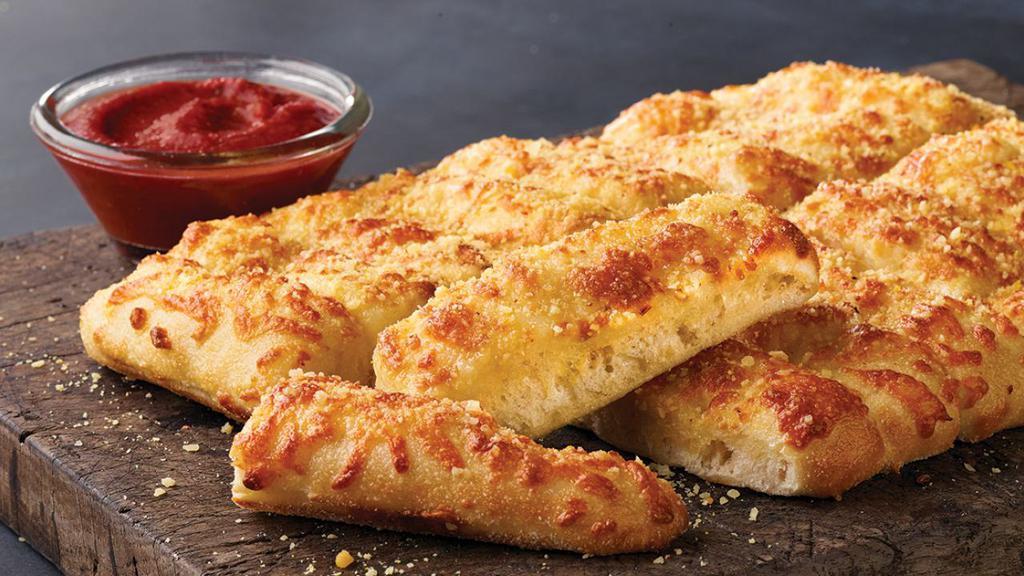 Cheezy Bread · Fresh-baked bread strips with our three-cheese blend and garlic butter, served with a side of pizza sauce and ranch dipping sauce.