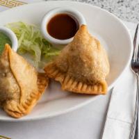 Samosa (2 Pieces) · Homemade triangular pastry filled with potatoes and green peas, lightly spiced with garlic, ...