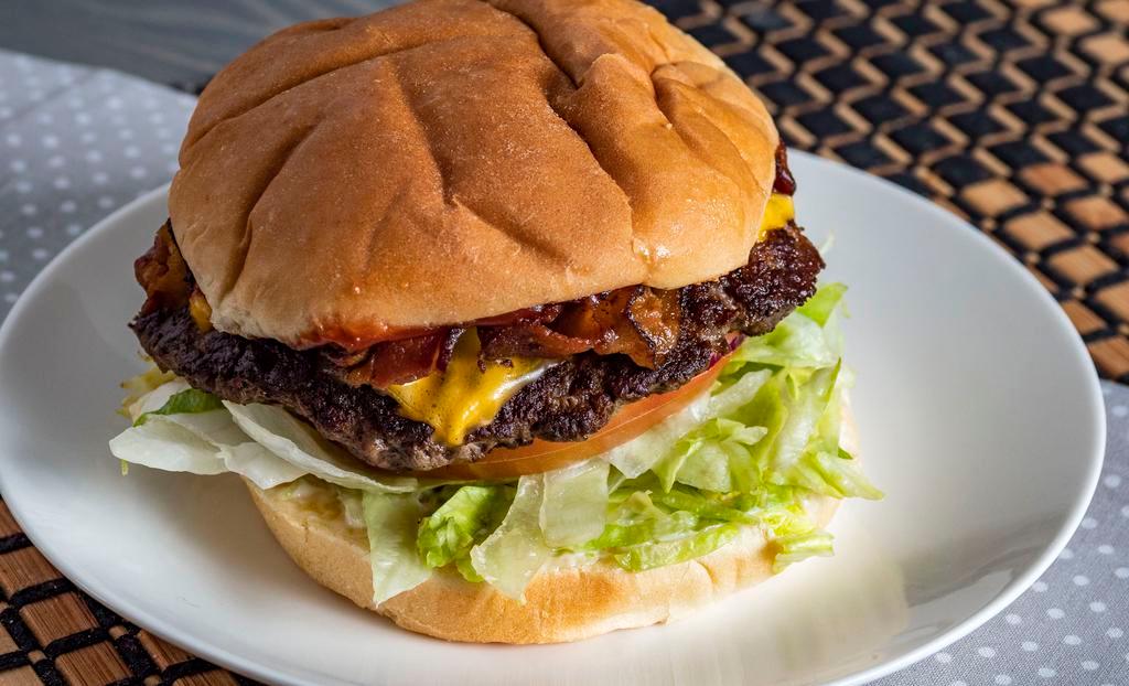 Bacon Cheese Burger · Handmade hamburger 1/3 pound of 100% ground beef. fresh with lettuce bacon cheese tomato onion mayonnaise mustard and ketchup.