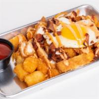 Loaded Breakfast Tots · Tater tots topped with a fried egg, cheddar cheese, chicken tenders, bacon and sriracha aioli.