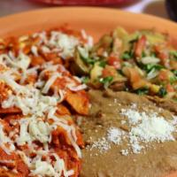 Chilaquiles · Fried corn tortillas pieces simmered with green or red salsa topped with cheese, served with...