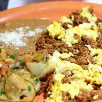 Huevos Con Chorizo · Scrambled eggs with Chorizo, served with refried beans, potatoes, cheese and tortillas.