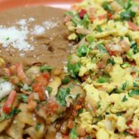 Huevos A La Mexicana · Mexican style eggs, served with refried beans, potatoes, cheese and tortillas.