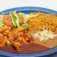 Camarones A La Diabla · Shrimps in spicy sauce, served with refried beans, rice, beans, salad and tortillas.