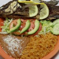 Pescado Frito · Fried fish tilapia, served with refried beans, rice, beans, salad and tortillas.