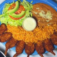 Camarones Empanizados · Fried breaded shrimps, served with refried beans, rice, beans, salad and tortillas.