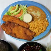 Filete Empanizado · Breaded fish fillet, served with refried beans, rice, beans, salad and tortillas.