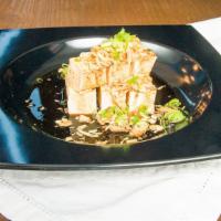 Cold Tofu · Top with green onions, fried red onions, and sweet ponzu sauce.