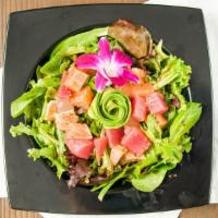 Sashimi Salad · Tuna, albacore, salmon, and avocado on top of spring mix salad with sashimi sauce.