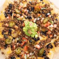 Plant Based Nachos Supreme · Chips smothered in our house queso topped with black beans, Screw Moo™ plant based protein,....