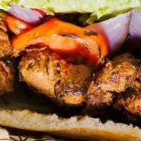 Steak Kabob Pita · Herb marinated steak kabobs grilled to perfection and served atop vine-ripened tomatoes, sum...