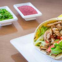 Shawarma Chicken Jumbo Wrap · Layered strips of marinated chicken delicately spiced & slow grilled, served in pita bread w...