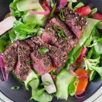 Peppered Ribeye Steak Salad · Gluten-free. Grilled peppered steak, red butter lettuce, Bleu cheese crumbles, roasted wild ...