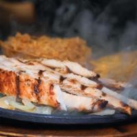 Fajitas · Choice of chicken or steak with grilled onions, bell peppers, guacamole, sour cream, and pic...