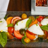 Caprese · Imported mozzarella, mix heirloom organic tomatoes, organic basil, extra virgin olive oil