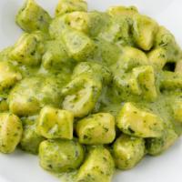 Gnocchi Al Pesto · Homemade gnocchi. fresh basil pesto, parmigiano