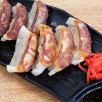 Gyoza · Eight pieces pan fried pork or vegetable dumplings.
