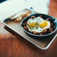 Hash Skillet · Chorizo, onions, peppers, two eggs, potatoes, topped with spanish tomato sauce.