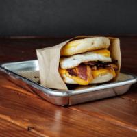 Breakfast Sandwich  · Toasted english muffin, selection
of bacon or sausage, fried egg,
cheddar cheese, and aioli ...