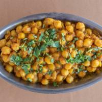 Chana Masala · Gently cooked chickpeas, tomatoes, onions and herbs.