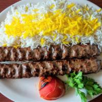 Chelo Kabob Koobideh · Two skewers of juicy strips of charbroiled seasoned ground beef served with basmati rice and...