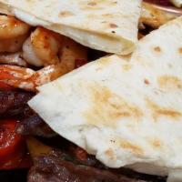 Fajitas Mixtas · Shrimp, chicken, and steak cooked with green and red bell peppers, onions, and spices. Serve...