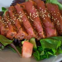 Seared Ahi Salad · Mixed greens, tomatoes, cucumbers, red onions, fire roasted corn and topped with roasted ses...
