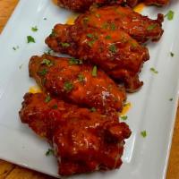 Buffalo Chicken Wings · Fried wings tossed in hot sauce and served with ranch dressing and celery sticks.