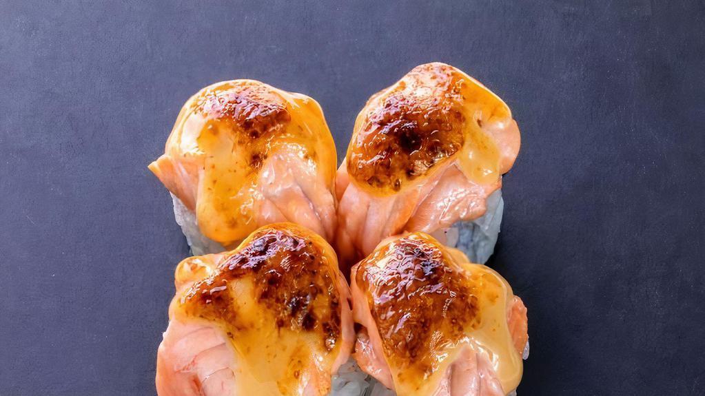 Baked Salmon Roll (4 Pcs) · California roll topped with baked salmon and dynamite sauce.