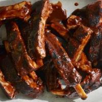 Baby Back Ribs · 12 pieces of tender, juicy baby back pork ribs. Smothered in tangy BBQ sauce.
