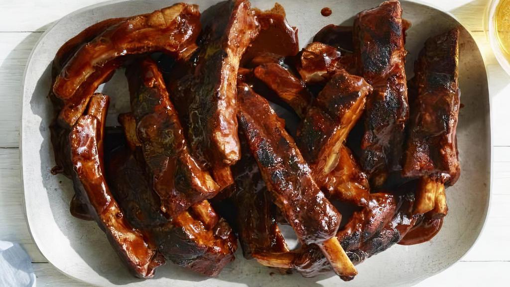 Baby Back Ribs · 12 pieces of tender, juicy baby back pork ribs. Smothered in tangy BBQ sauce.