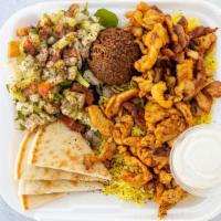 Chicken Shawarma Platter · Includes yellow rice, pita bread, one falafel, salad, tahini sauce, and our signature garlic...