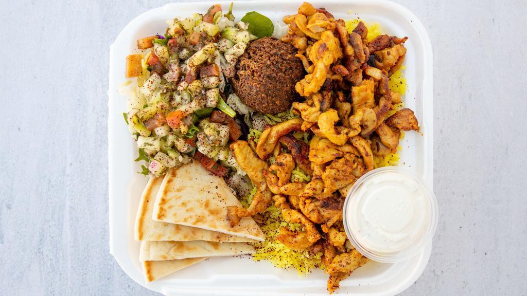 Chicken Shawarma Platter · Includes yellow rice, pita bread, one falafel, salad, tahini sauce, and our signature garlic sauce.
